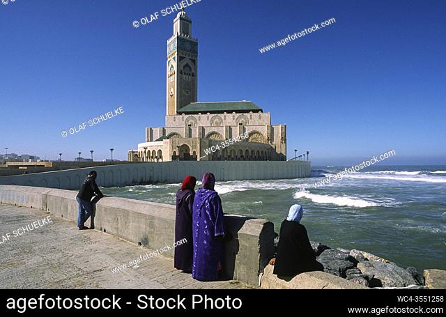 Casablanca, Morocco, Africa - Veiled women are seen at the shore in front of the Hassan II Mosque, the second largest mosque in Africa