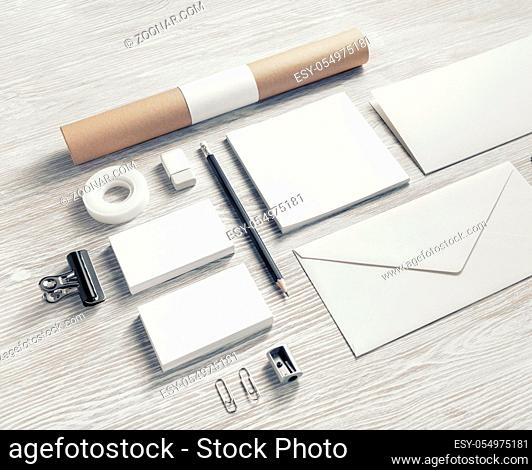 Photo of blank stationery set on light wooden background. Corporate identity mock up for placing your design