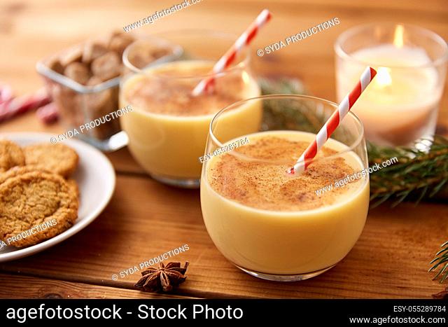 glasses of eggnog, oatmeal cookies and fir branch