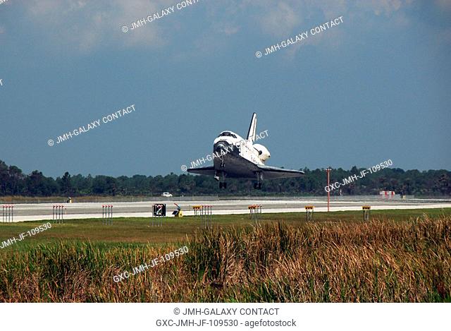 Space Shuttle Discovery touches down on runway 15 of the Shuttle Landing Facility at NASA's Kennedy Space Center, concluding the 14-day STS-124 mission to the...