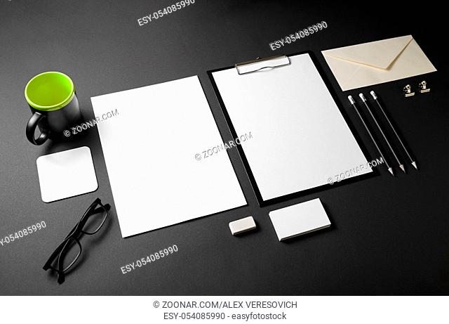 Photo of blank stationery set on black paper background. Corporate identity template. Responsive design mockup