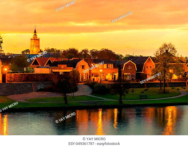 city skyline of Leerdam the netherlands at sunset with water and park view