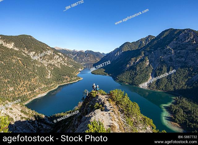 Two hikers looking into the distance, view of Plansee, Schönjöchl in the background, hike to the Schrofennas, Ammergau Alps, Reutte district, Tyrol, Austria