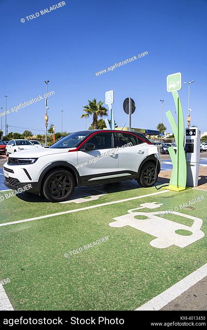 Electric car charging station symbol and car charging, Palma, Mallorca, spain