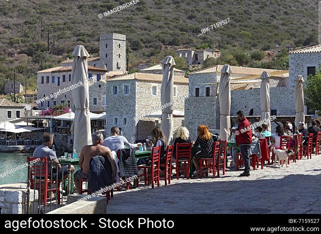 Terrace of a tavern, many guests, view of Limeni village, Thodora's Place restaurant, Mani peninsula, Lakonia, Peloponnese, Greece, Europe