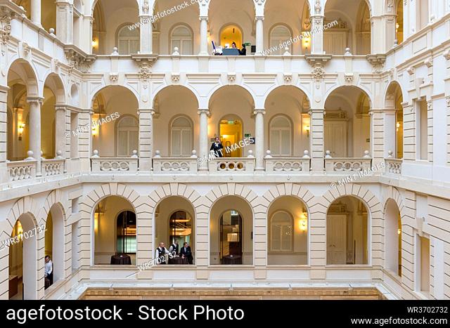 Hotel, a historic building with atrium and walkways, classical architecture, people on each level