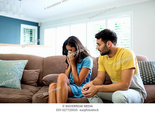 Couple arguing with each other in living room
