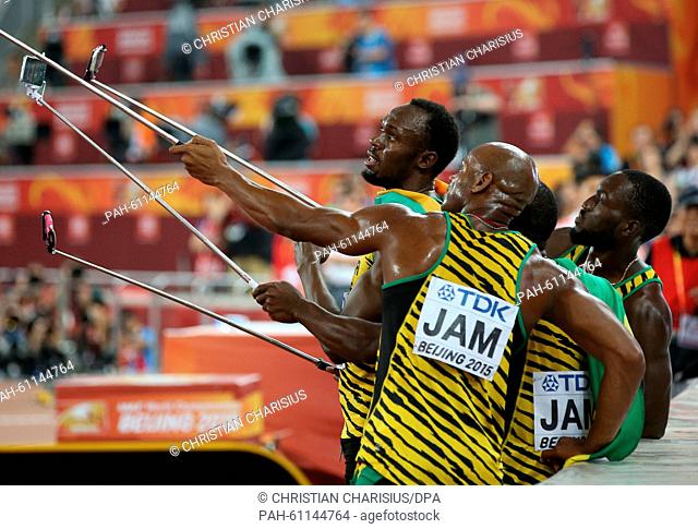 Jamaica's relay team with (L-R) Usain Bolt, Asafa Powell, Nesta Carter, Nickel Ashmeade take selfies after winning the the 4 x 100m Relay final at the 15th...