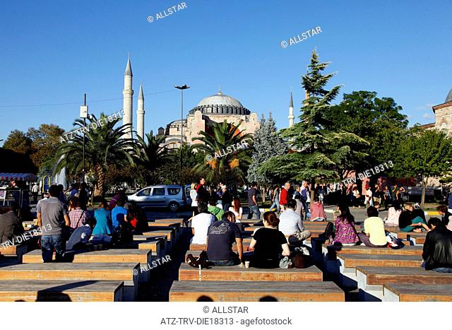 PEOPLE ON BENCHES NEAR HAGHIA SOPHIA MOSQUE, AYA SOFYA; SULTANAHMET, ISTANBUL, TURKEY; 03/10/2011