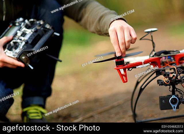 Closeup of man hand fixing propeller drone
