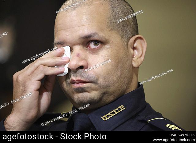 Sgt. Aquilino Gonell of the US Capitol Police wipes tears away as a video showing scenes of the January 6th attack is played before members of the Select...