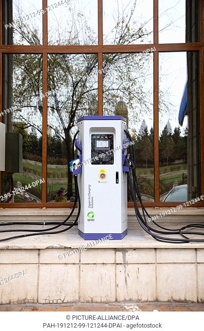 01 December 2019, Romania, Bukarest: A charging station for electric vehicles stands in front of a building of the Ministry of the Environment and Climate...