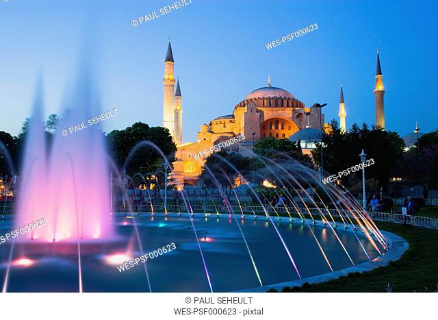 Turkey, Istanbul, Sultanahmet, People watching light show of fountain with Haghia Sophia in background