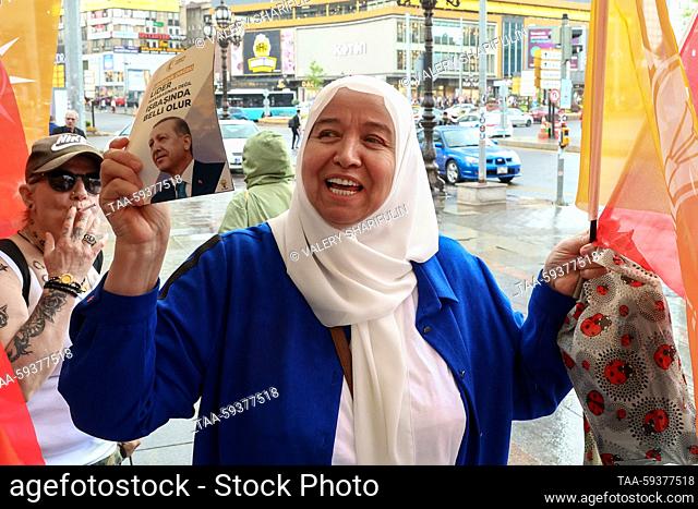 TURKEY, ANKARA - MAY 25, 2023: A woman holds a leaflet promoting presidential candidate and incumbent president Recep Tayyip Erdogan