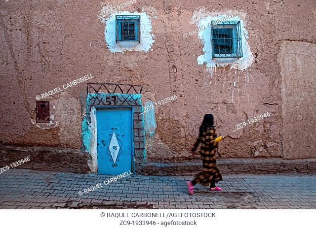 Young girl walking by the alleyways of the mellah, Ouarzazate, Morocco
