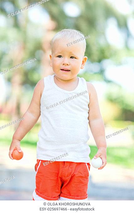 Baby boy playing toy golf outdoor