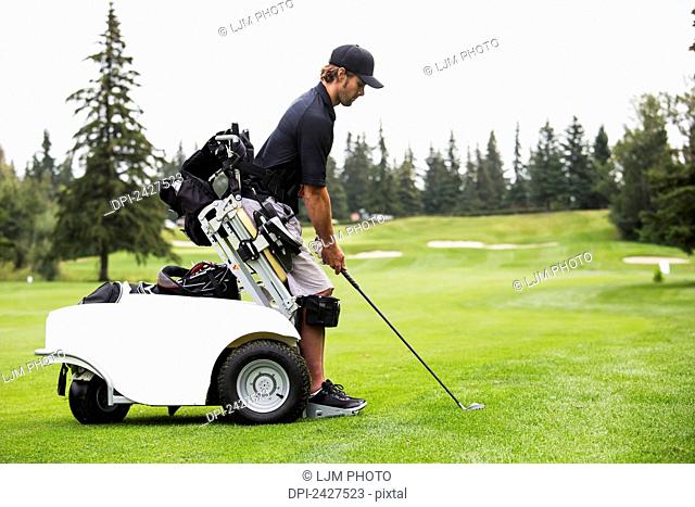 Disabled golfer in a tournament using high tech mobility aid; Edmonton, Alberta, Canada
