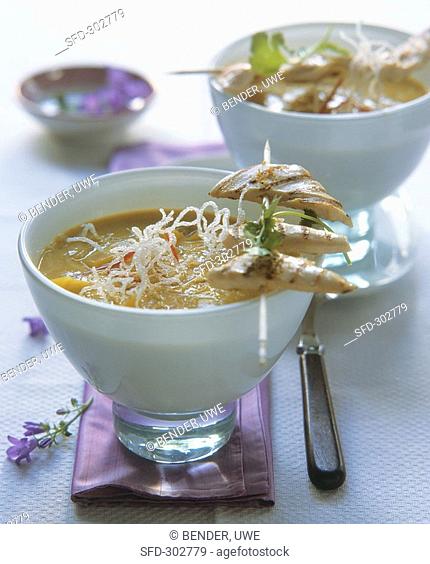 Curried mango soup with chicken skewer