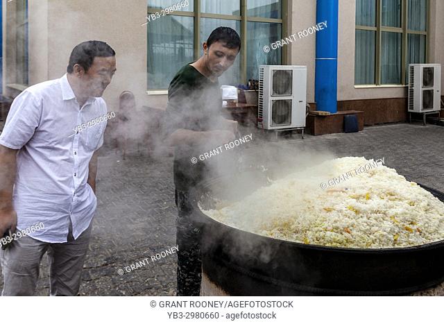 A Man Cooks Rice For PLOV (The National Dish) At The Central Asian Plov Centre, Tashkent, Uzbekistan