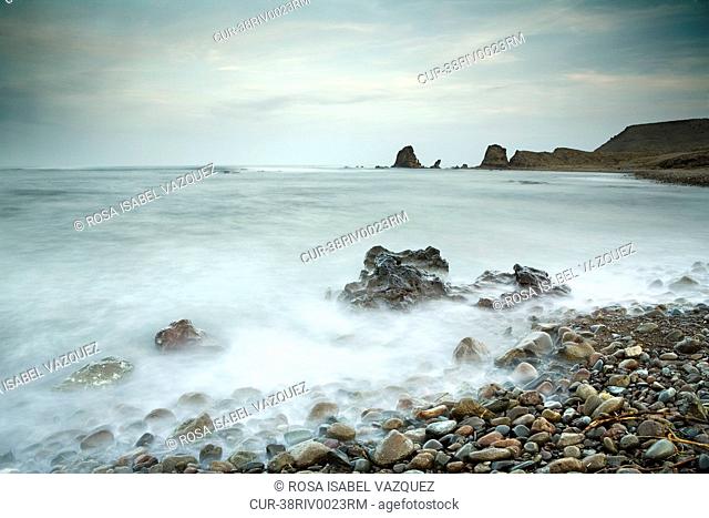 Time lapse view of waves on rocky beach