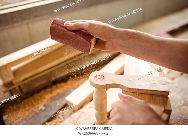 Man working over a wooden plank