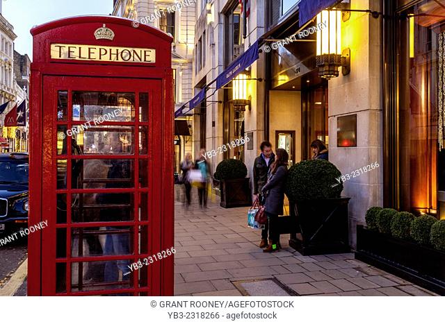 Traditional Red Telephone Box and Exclusive Shops In New Bond Street, London, England