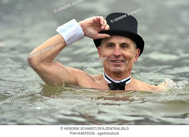 More than 60 New Year swimmers, including this gentleman in a top hat, bathed at Heidesee lake in Halle/Saale, Germany, 6 January 2016