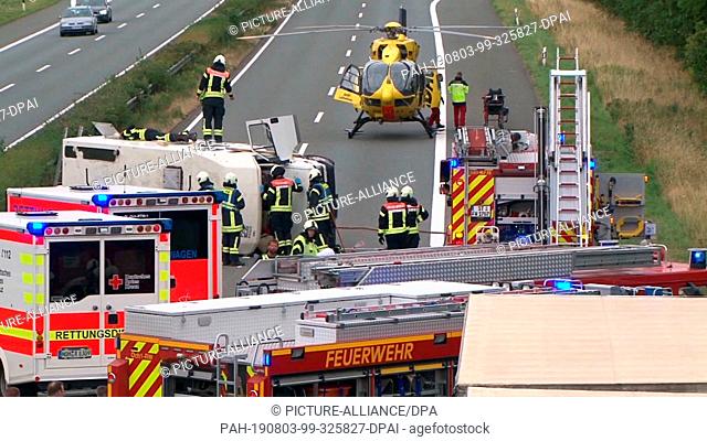03 August 2019, North Rhine-Westphalia, Ochtrup: After his accident with a motorhome, rescue workers are on duty on the Autobahn 31
