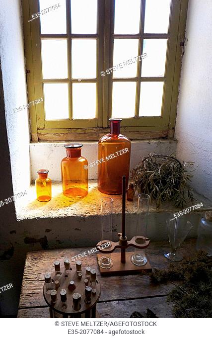 18th century, glass storage jars in the kitchen window of the Abbaye-Chateau Cassan, Roujan, France