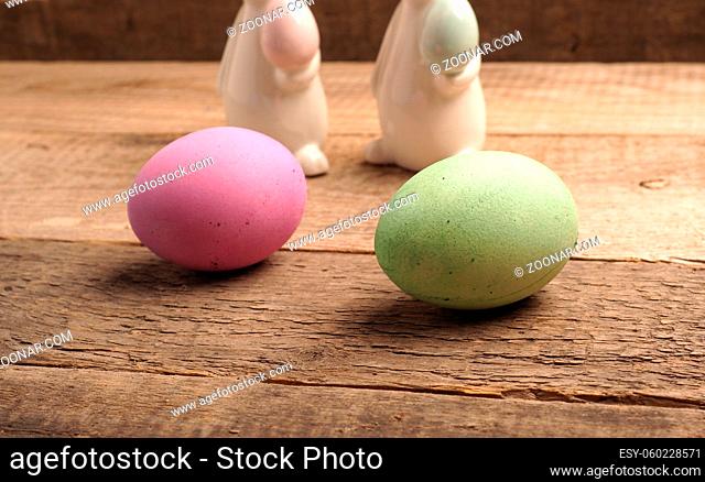 Naturally colored organic eggs on a rustic table with space for text, Easter background