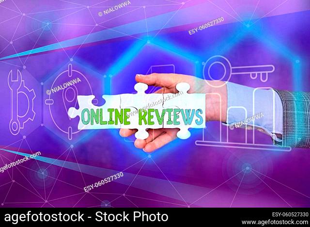 Text sign showing Online Reviews, Business showcase Product evaluation Customer feedback publish in the website Hand Holding Jigsaw Puzzle Piece Unlocking New...