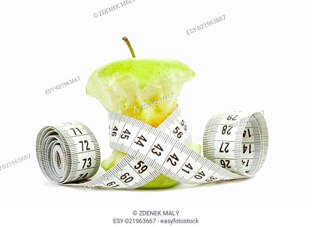 Green bitten apple isolated on white with measuring tape