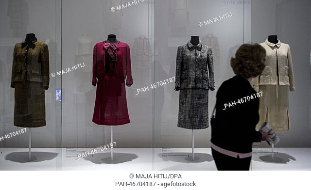 A woman looks at female suits during the exhibition 'Myth Chanel', about the fashion designer Coco Chanel in Hamburg, Germany, 27 February 2014