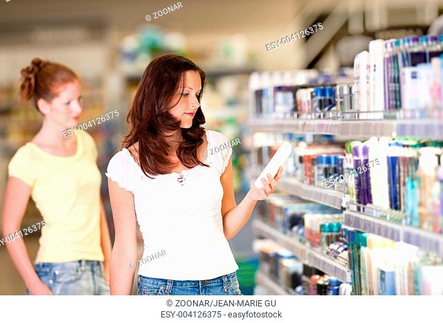 Shopping series - Woman holding bottle of shampoo