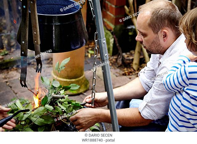 Father Making Bonfire In Garden