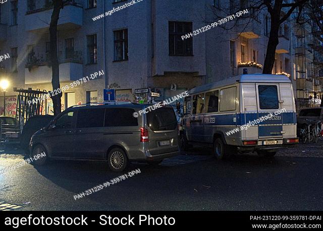 20 December 2023, Berlin: A police car stands in front of an apartment building during a search operation. The Berlin police raided a left-wing feminist women's...