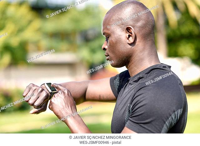 Runner checking smart watch fitness tracker