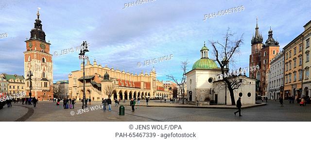 An overview of the Main Market Square with the historic town hall tower (l-r), the Cloth Hall and the twin-towered St. Mary's Church in Krakow, Poland