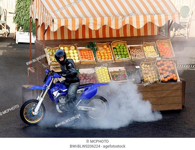 biker in front of a fruitstall