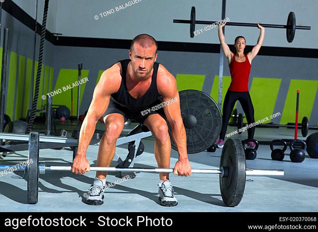 gym with weight lifting bar workout man and woman