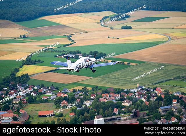 08 July 2021, Bavaria, Giebelstadt: During training to become an air observer, a pilot and a student fly a training flight near Giebelstadt in a small Echo...
