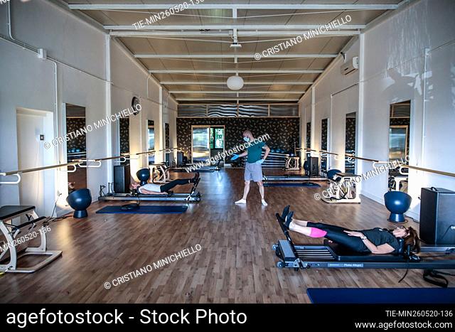 People during a pilates reformer class in a gym reopened after the lockdown due Covid-19 emergency , Rome, ITALY-26-05-2020