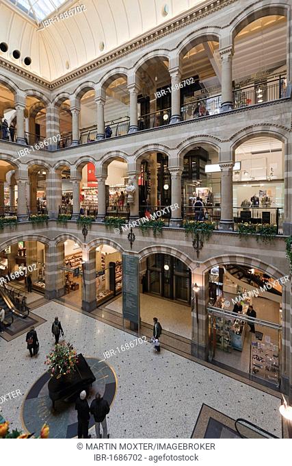 Arcades in the inner courtyard of Magna Plaza shopping centre in the former building of the Main Post Office, Nieuwezijds Voorburgwal, Amsterdam, Holland