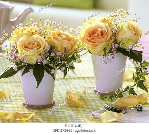 Roses with Gypsophila and ivy in pink vases