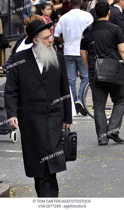 An elderly Jewish man walks down the streets of New York City