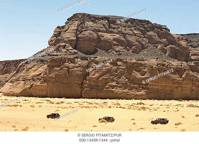 4x4 vehicles near rock formations, Wadi Teshuinat, Tadrart Acacus, Fezzan, Libya