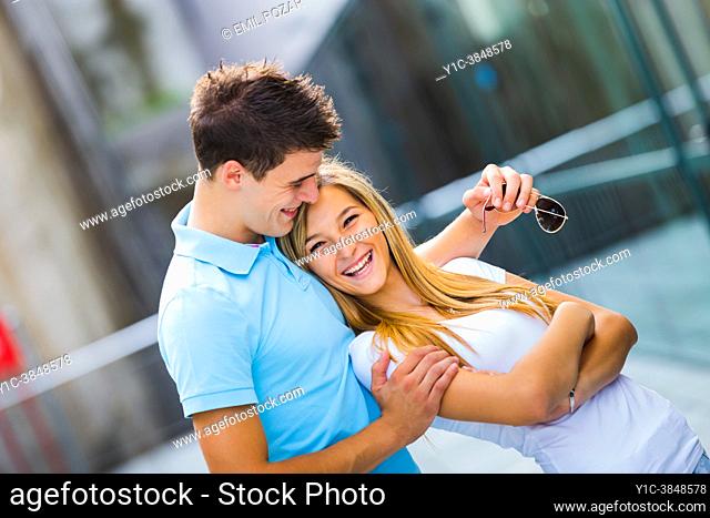 Adolescent teen couple together laughing very happy