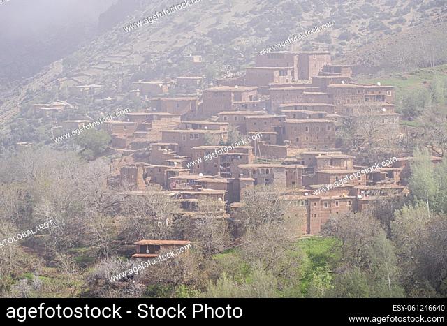 typical adobe houses in the fog, Ait Blal, Atlas mountain range, morocco, africa