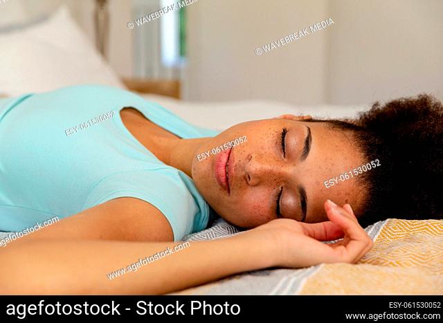 Mixed race woman lying in a bed sleeping
