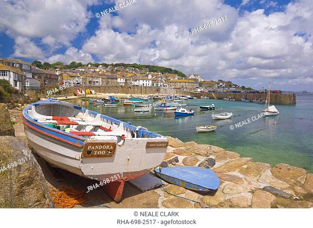 Small boat on the quay and small boats in the enclosed harbour at Mousehole, Cornwall, England, United Kingdom, Europe